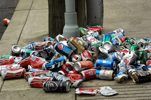 Pile of beer cans on the street.